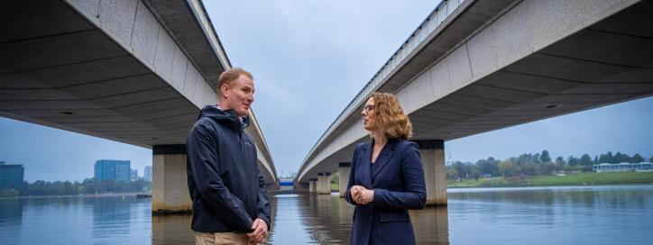 Photo of Greg Tallentire and Alicia Payne MP standing beneath Commonwealth Avenue Bridge