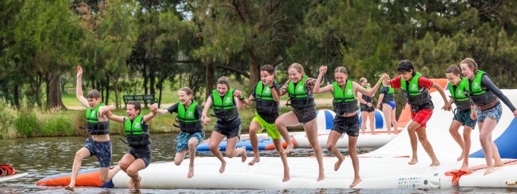Kids jumping into the lake at the Aqua Park