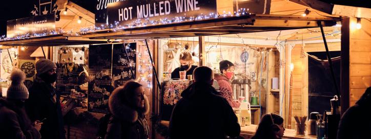 People enjoying food stalls at a night market