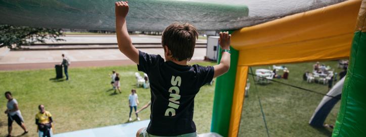 A child jumping off an inflatable obstacle.
