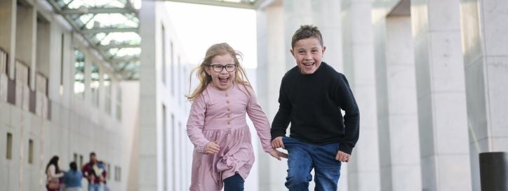 Kids joyfully running toward the camera
