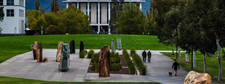 An image of the stone artworks at Reconciliation Place. You can see the National Library of Australia and Telstra Tower in the distance.