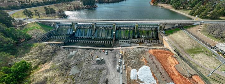 This image is a drone photo of Scrivener Dam showing the early construction of the access roads down to the dam.