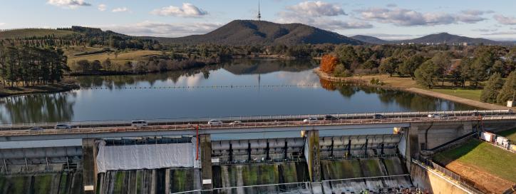 This image is an aerial shot of Scrivener Dam showing the encapsulation within the sluice and flood gates with a view to Telstra Tower.
