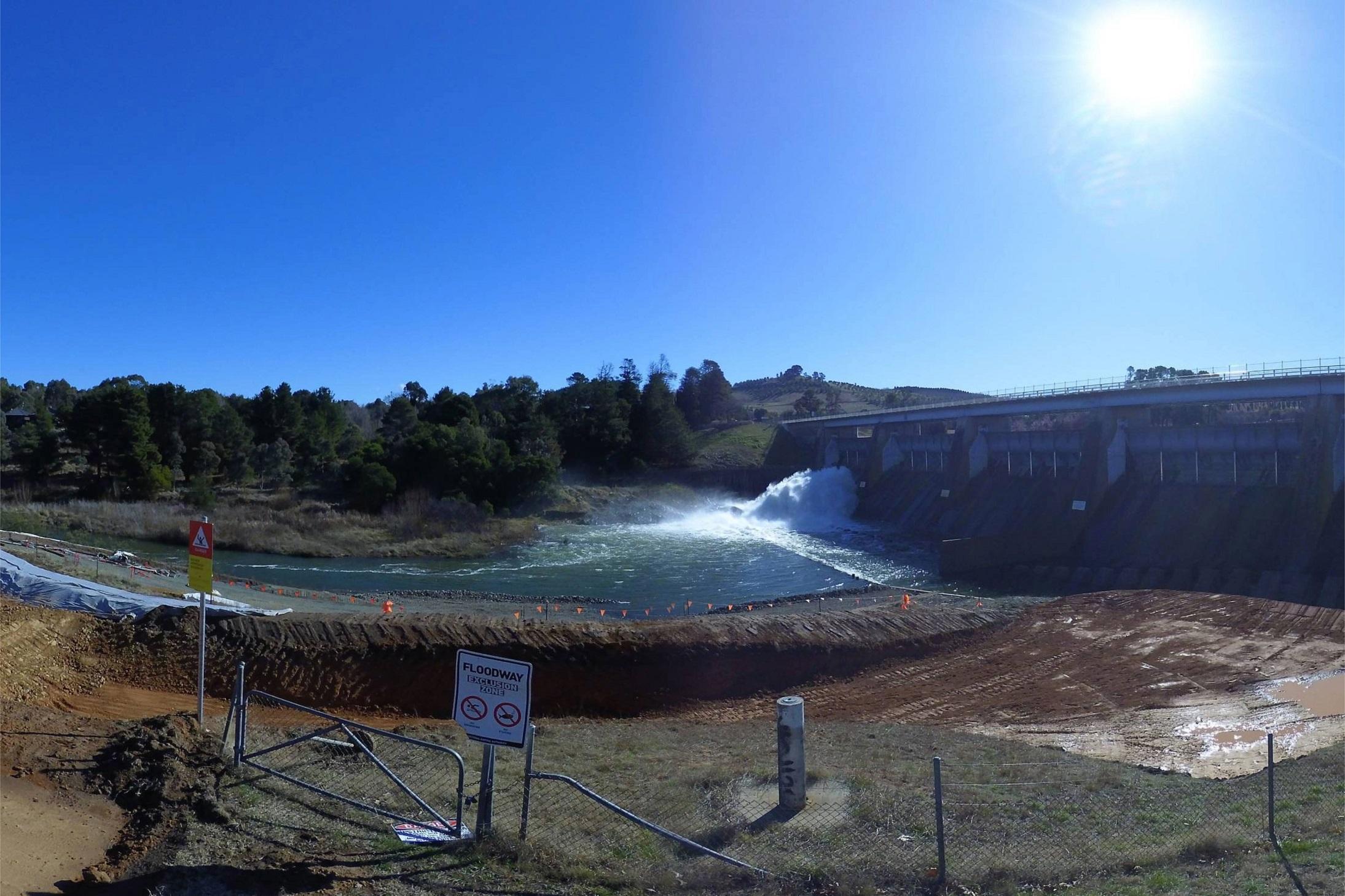 This is image is from a timelapse camera showing the dam full of water and a sluice gate open.