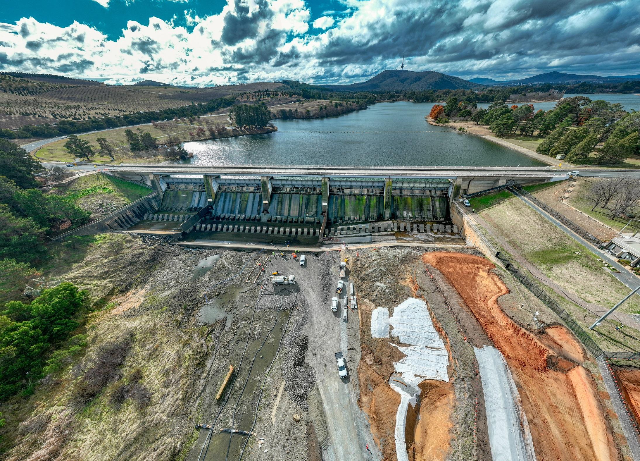 This image is a drone photo of Scrivener Dam showing the early construction of the access roads down to the dam.