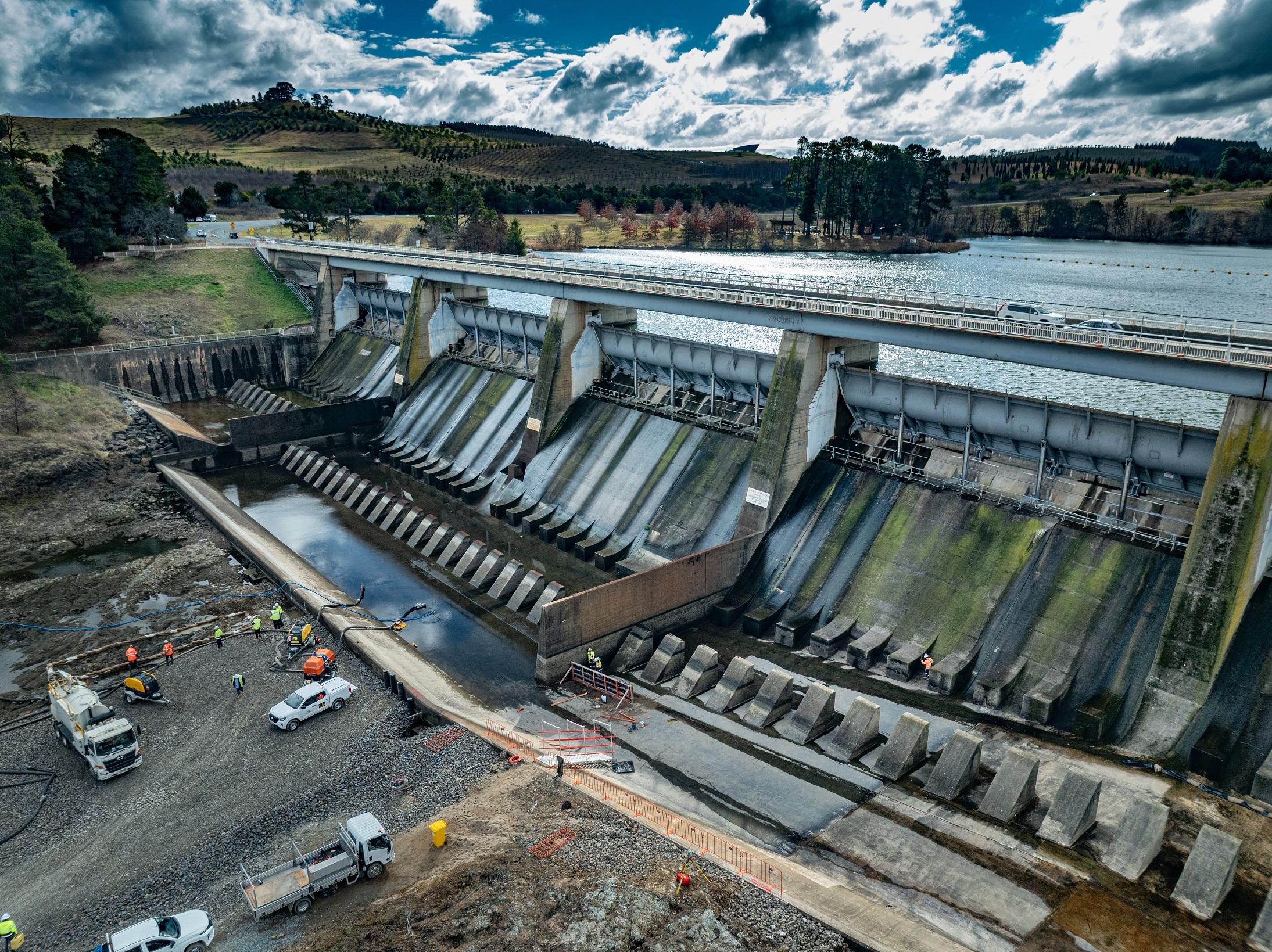 This image is a drone photo of Scrivener Dam showing the early construction of the cofferdam.