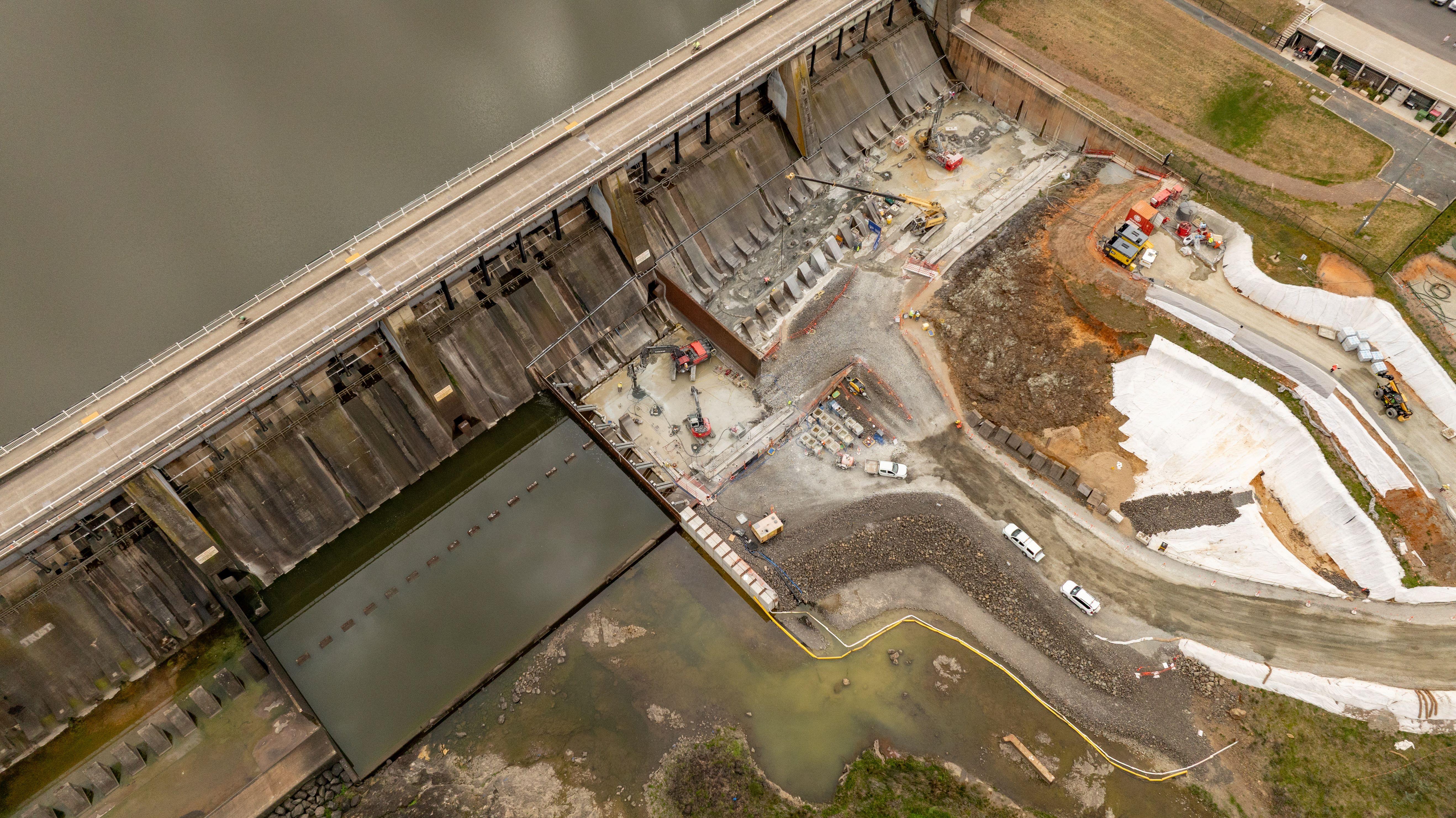 Drone shot taken from above Scrivener Dam showing construction activities underway