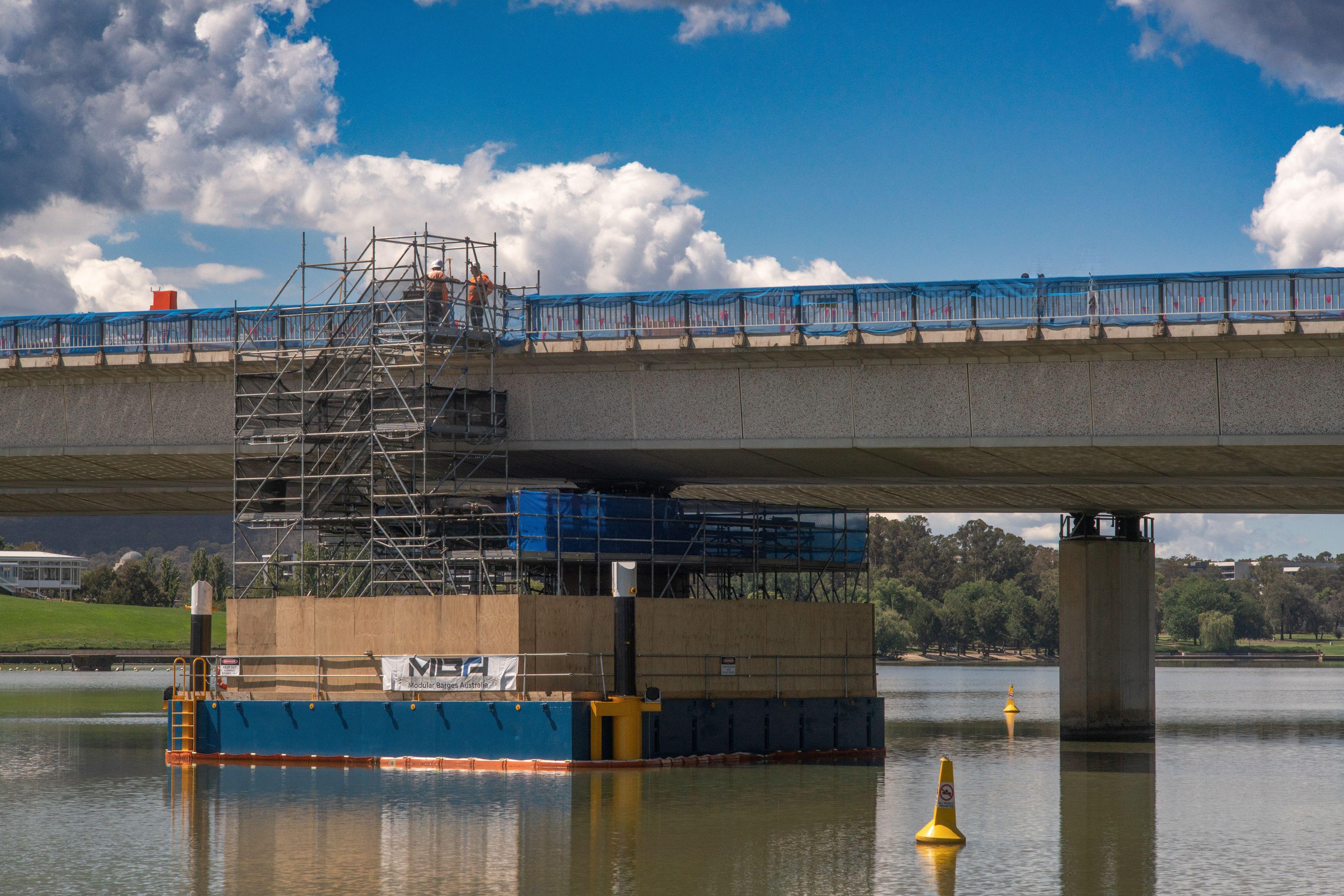 Image is of the barge in the water at Comm Ave Bridge where workers are undertaking the first pier lift.