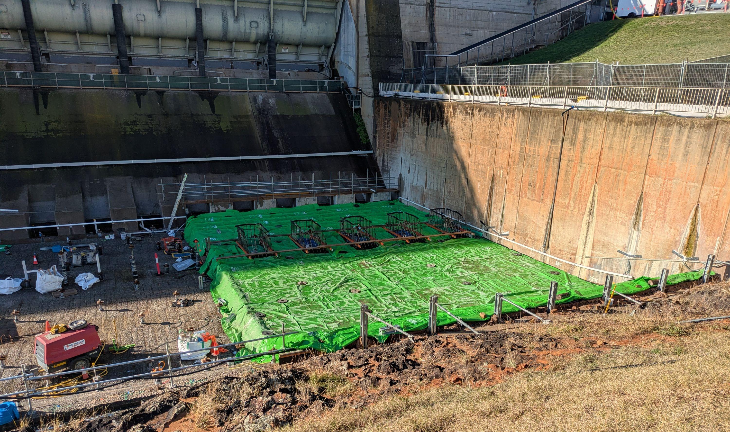 This image shows the heat blankets laid on the freshly poured concrete slab to support its curing period.