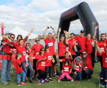 MS Walk run and roll participants at finishing line. A group of happy people.