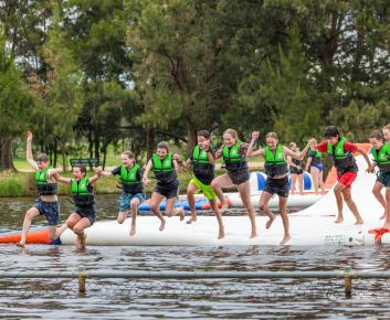 Kids jumping into the lake at the Aqua Park
