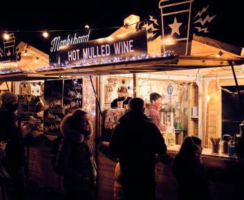 People enjoying food stalls at a night market
