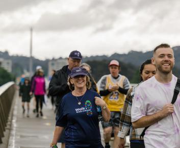 Happy, fulfilled people walking in the rain with smiles on their faces