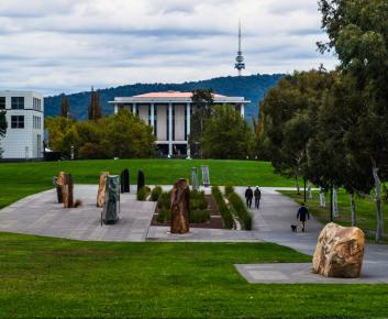 An image of the stone artworks at Reconciliation Place. You can see the National Library of Australia and Telstra Tower in the distance.