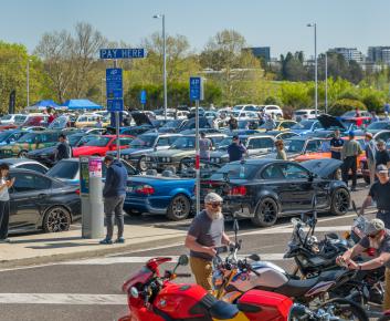 Cars parked in a large parking lot at an official event